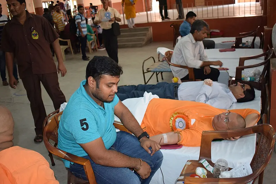 Volunteers donating blood at a community blood donation camp