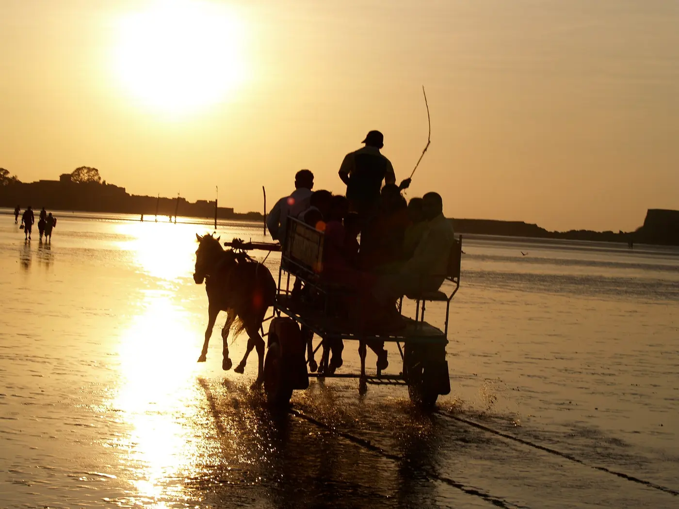Evening light on Alibag beach with a horse cart at the water
